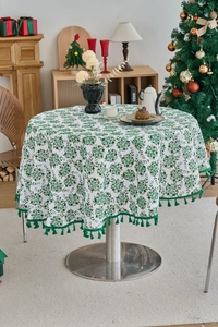 Detail of pine branch pattern tablecloth with green tassels for Christmas decor