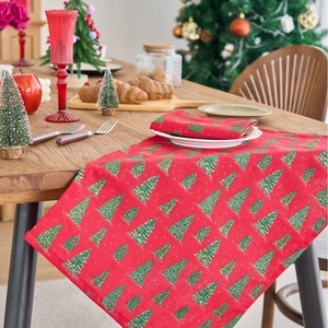 Christmas table runner and napkin set with green tree patterns on festive red fabric