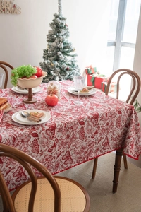 Detailed embroidery of festive butterflies and red flowers on a jacquard tablecloth