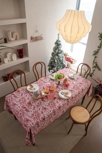 Macro shot of red festive jacquard tablecloth with floral butterfly embroidery patterns