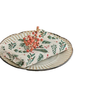 Christmas cotton linen napkin with green leaves and red berries floral print on beige fabric