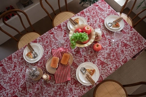 Macro detail of red and white butterfly floral jacquard pattern on Christmas tablecloth