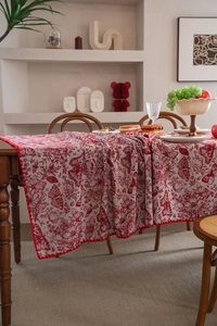 Close-up of red butterfly toile de jouy jacquard tablecloth with floral patterns