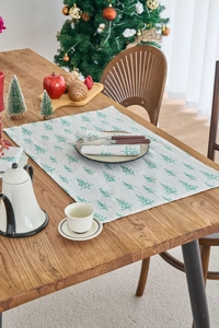 Detailed macro view of green maple leaf print on rustic cotton linen holiday napkins