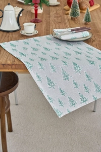 Detailed texture of Christmas table runner with green tree print on linen fabric