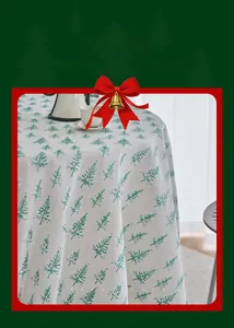 Detailed macro view showing green pine tree print on beige linen texture tablecloth