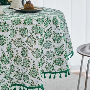 Festive round tablecloth with green pine branch print and elegant fringe tassels