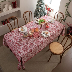 Red festive Christmas tablecloth with jacquard floral and butterfly patterns on wooden table