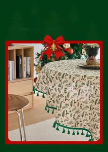 Detail of pine needle print tablecloth with red berries and green tassels for Christmas