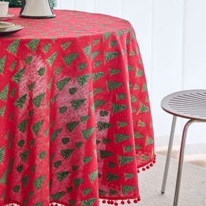 Festive red round Christmas tablecloth with green tree prints and pom-pom fringe edge