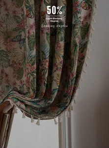 Detail of vintage floral curtain fabric featuring jacquard butterflies and elegant tassels