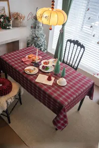 Classic red and green plaid tablecloth detail for festive Christmas dining room decor
