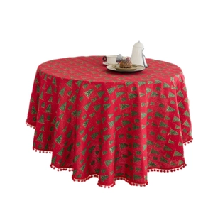 Red round Christmas tablecloth with pine tree print and decorative plush ball fringe
