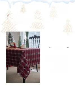 Detail of soft red and green plaid woolen tablecloth with festive Christmas snowflake border