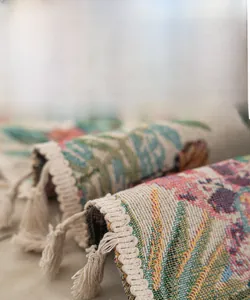 Detailed close-up of bohemian tassel fringe with floral and butterfly jacquard fabric