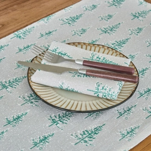 Christmas pine tree print cotton linen table runner and napkins on dark wood table