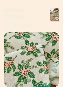 Close-up of beige Christmas table runner with holly leaf prints and gold foil details