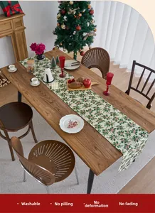Christmas table runner with holly leaf print on cream fabric, durable and colorfast
