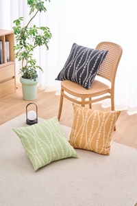Detail of floral stripe pattern on black, green and yellow decorative cushion covers