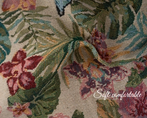 Detailed macro view of woven jacquard fabric with floral and butterfly patterns