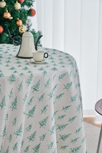 Close-up of pine tree print on beige tablecloth with textured cotton linen fabric