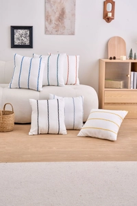 Detailed embroidery on white square cushion covers with modern geometric lines for sofas