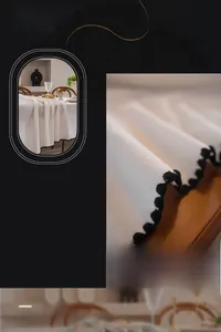 Detail of white tablecloth with black pom-pom trim edge in premium cotton blend fabric