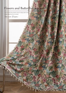Close-up of jacquard fabric with floral and butterfly patterns and elegant fringe details