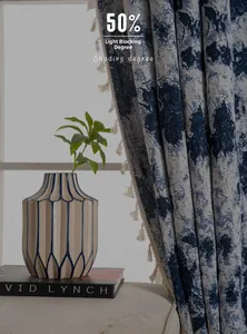 Detail of blue and white geometric jacquard curtain with elegant fringe and 50% shading