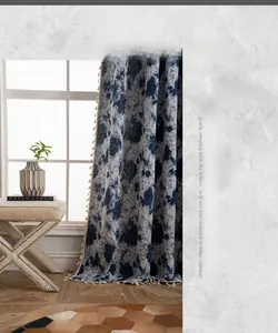 Detailed view of navy blue jacquard curtain with white tassel fringe and floral pattern
