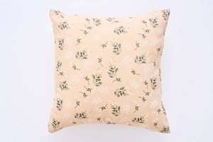 Detailed close-up of square floral cushion cover with yellow and white flowers on linen