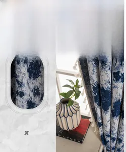 Detailed view of blue floral polyester fabric with decorative off-white side tassels