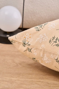 Close-up of floral pillow cover featuring delicate stitching and linen fabric texture