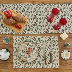 Christmas table runner and placemats set with green pine needles and red berry prints