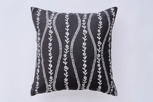 Macro detail of square black and white floral pillow cover with wavy textured fabric