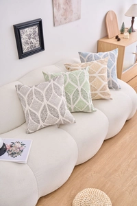 Detailed view of four colorful geometric cushion covers in textured woven cotton linen