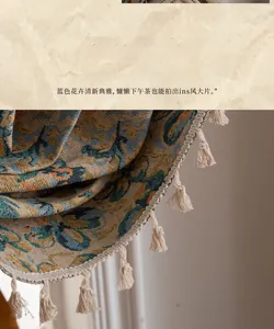 Close-up of vintage floral jacquard fabric with handcrafted white tassel fringe detail