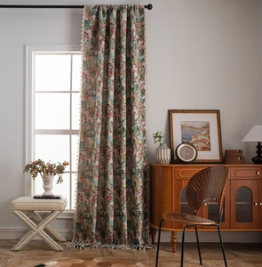 Detail of floral jacquard curtain fabric with decorative white fringe tassels