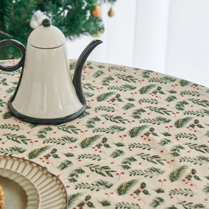 Christmas pine branch print tablecloth on a round dining table for festive home decoration