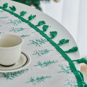 Christmas table runner with green pine tree embroidery and festive tassels decoration