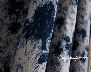 Detail of blue and beige floral jacquard fabric showing soft texture and elegant drape