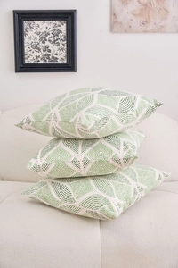 Detailed close-up of three stacked cushion covers with green geometric leaf patterns