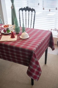 Close-up of thick red tartan tablecloth with festive green and white woven patterns