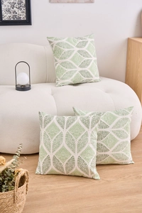 Detailed texture of cotton linen cushion covers with green geometric leaf patterns