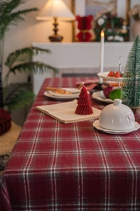 Close-up of red and grey plaid textured fabric tablecloth for Christmas dining table decoration