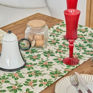 Christmas table runner with green holly leaf print on beige linen fabric for festive decor