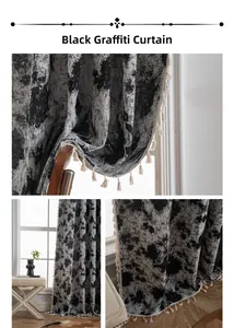 Detail of black graffiti art style curtain fabric with thick texture and cream tassels
