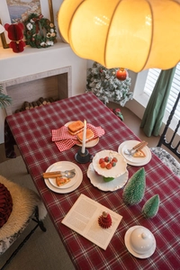 Close-up of red and green plaid Christmas tablecloth in retro cottage style