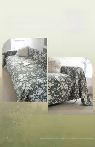 Detail of floral sofa cover with dark green fabric, thick texture and fringed edges