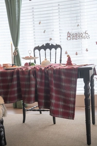 Close-up detail of thickened red and green plaid tablecloth with classic festive pattern
